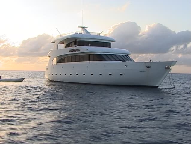 Motor boat in the ocean on sunset