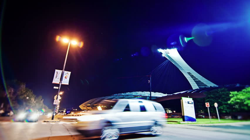 MONTREAL - OLYMPIC STADIUM - JUNE-2012: Night time lapse of
Traffic and cars traveling on Pierre-de-Coubertin Avenue 14th of June 2012 - Montreal Olympic Stadium