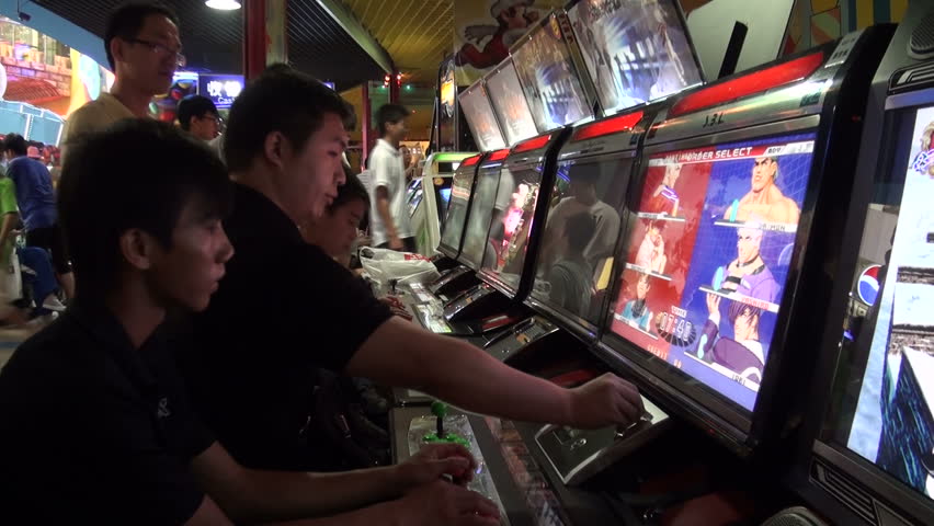 GUANGZHOU - AUGUST 9 2010: Young men are playing games in a shopping mall in Guangzhou, China