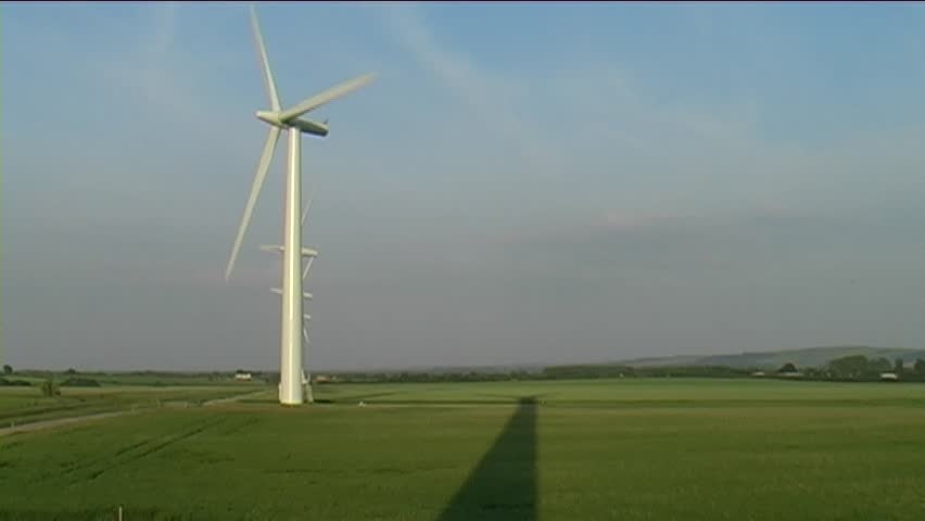 A wind farm in the english countryside on a summers evening.