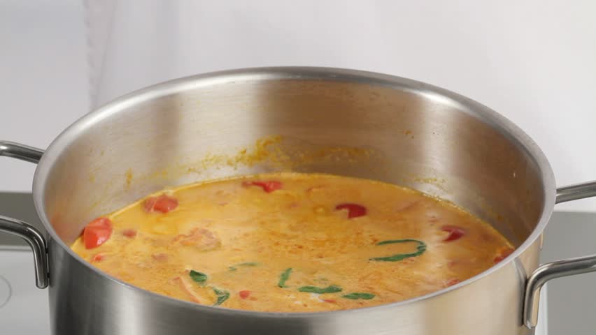 Pureeing tomato soup with a hand blender