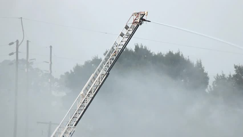Water Cannon On Extended Ladder At Outdoor Fire In Operation