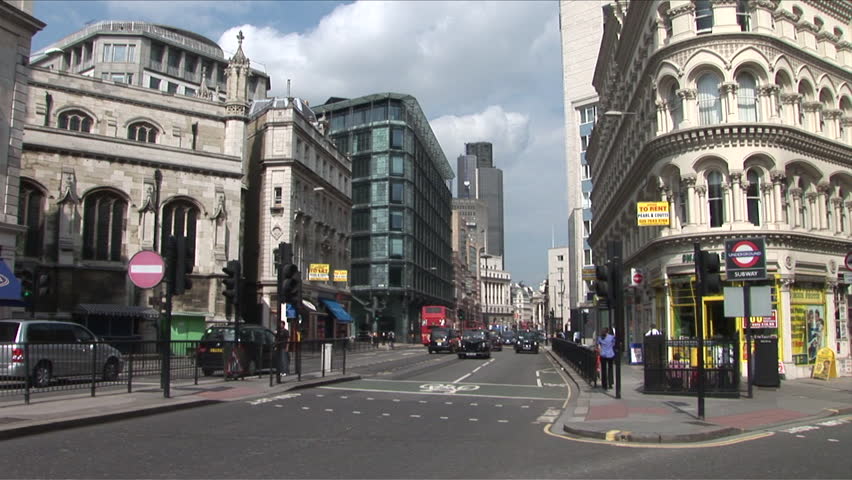 London, England - CIRCA June, 2006: A typical street in London during the day with cabs and other cars driving around