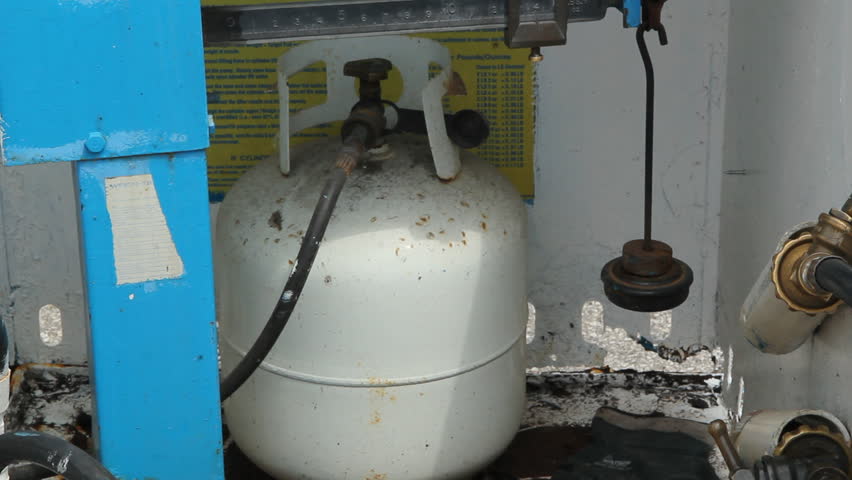 TORONTO, CANADA â JUNE 12th: Filling up a propane tank on June 12th, 2012.  Propane is one of a group of liquefied petroleum gases.
