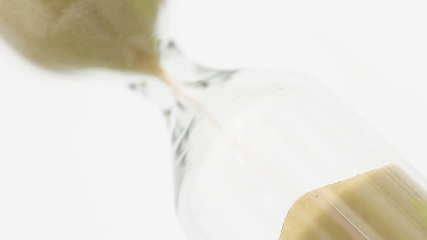 Sand falling in hourglass - passing time concept