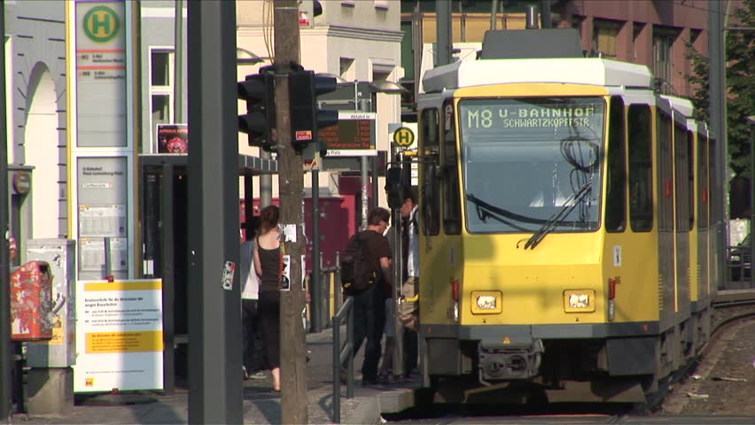 Berlin, Germany - CIRCA June, 2006: A yellow tram pulls into the station and picks up passengers