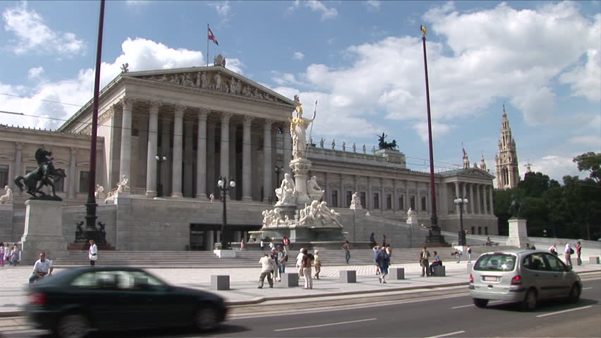 Vienna, Austria - CIRCA June, 2006: Traffic passes by and people take pictures in front of the Parliament building