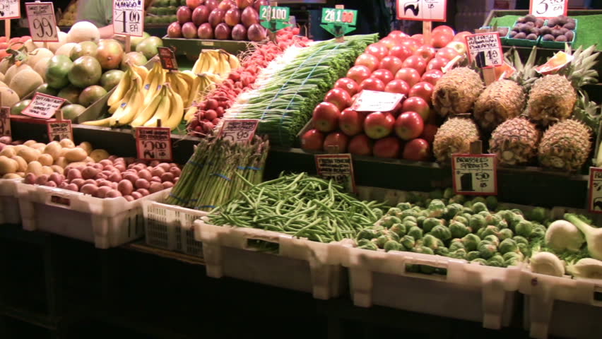 Produce stand panning shot showing beautiful, colorful fruits and vegetables.