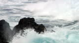 Slow motion video of wave breaking on rock