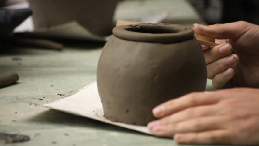 Pottery class workshop. Clay shaping on potter's wheel.
