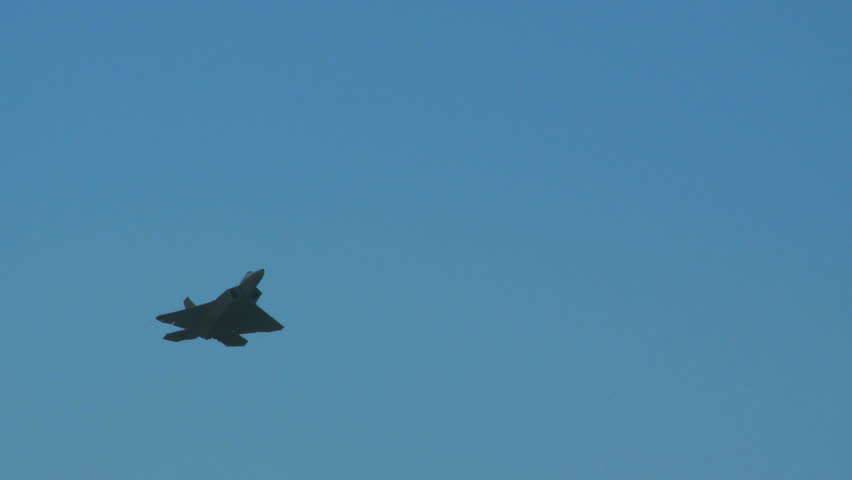 QUONSET, RHODE ISLAND - JUNE 2012: Air force F-22 Raptor flying by while rolling at the Rhode Island National Guard Open House and Air Show in June 2012.