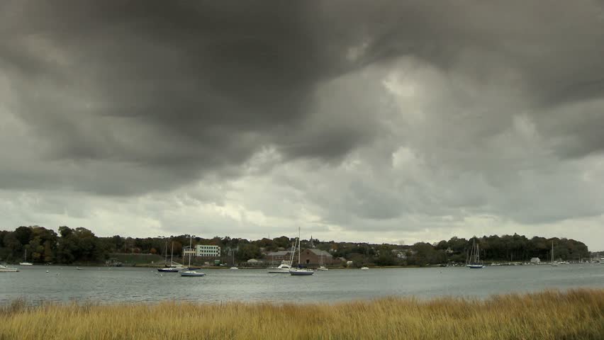 Storm clouds brewing over small fishing cove 