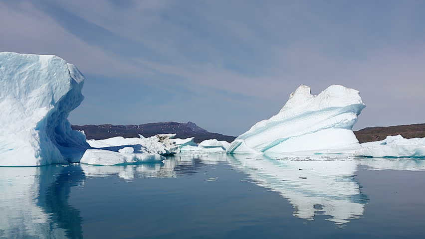 Drifting by an iceberg floating in Qooroq Icefjord, South Greenland