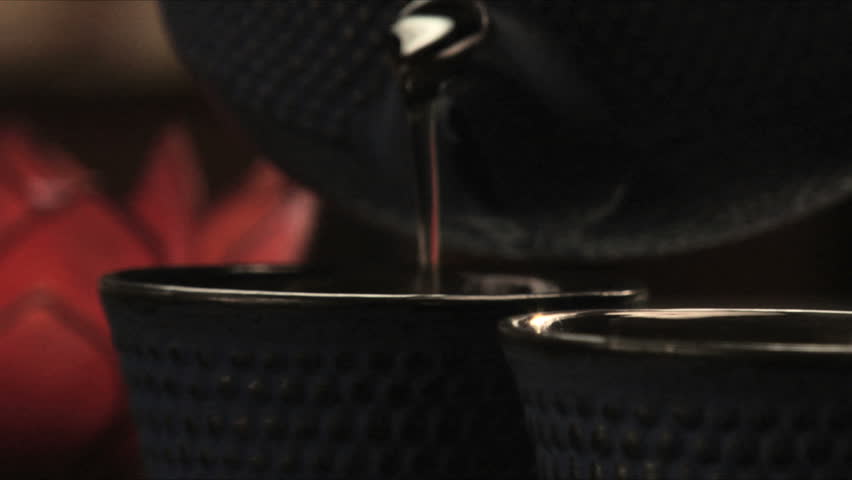 Pouring tea into asian style cups