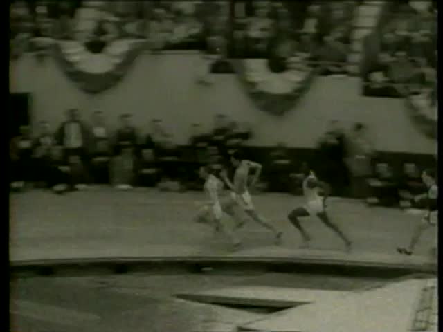 Tom Carroll wins 1000 yard run at the track season of the Boston Athletic Association Indoor Meet in Boston circa 1958 - MGM PICTURES, UNIVERSAL-INTERNATIONAL NEWSREEL, USA, filmed in 1958