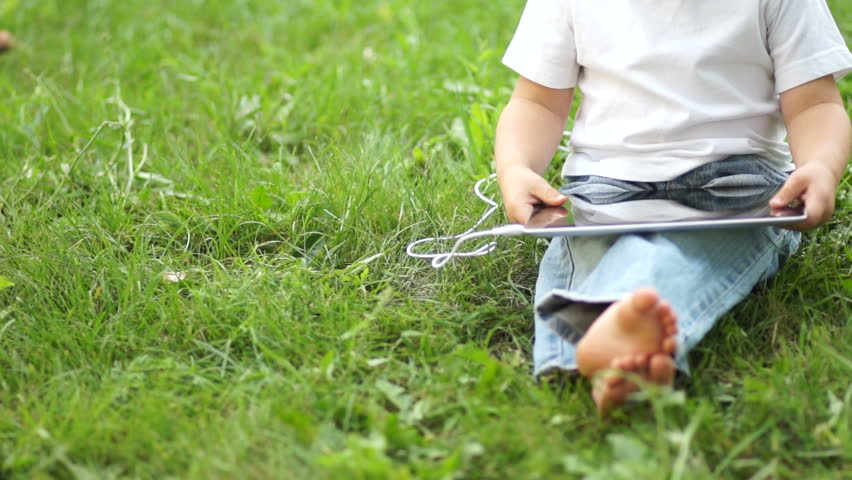 Boy with a tablet pc in the headphones
