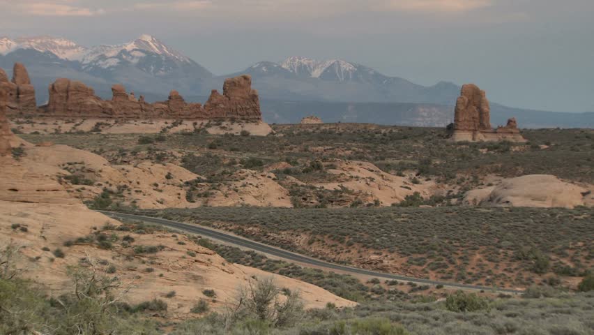 RV from a distance driving through Arches National Park