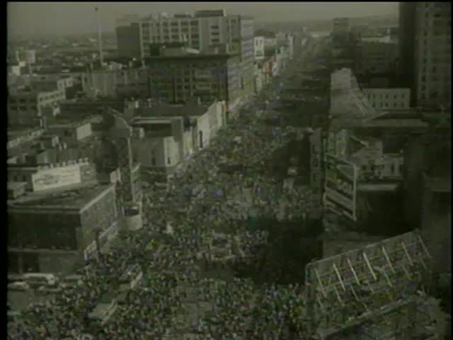 People celebrate Mardi Gras Parade in New Orleans circa 1958 - MGM PICTURES, UNIVERSAL-INTERNATIONAL NEWSREEL, USA, filmed in 1958