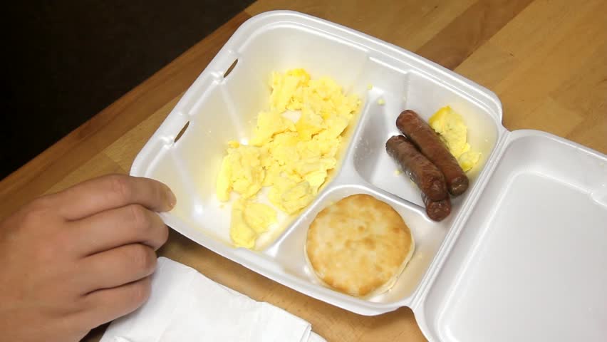 Plastic Fork Picks At Scrambled Eggs In Styrofoam Breakfast Container