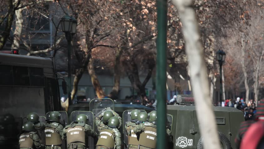 SANTIAGO, CHILE - AUGUST 9: Riot police disperse protesters during a student strike on August 9, 2011 in Santiago, Chile. Protesters demand the government to improve education quality.