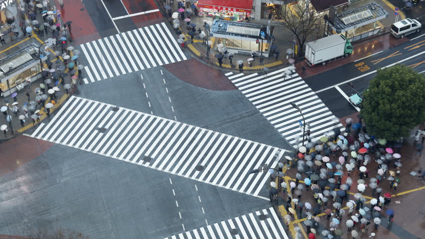 Shibuya Crossing - crowds of people crossing the famous crosswalks at the centre of Shibuyas fashionable shopping and entertainment district, Tokyo