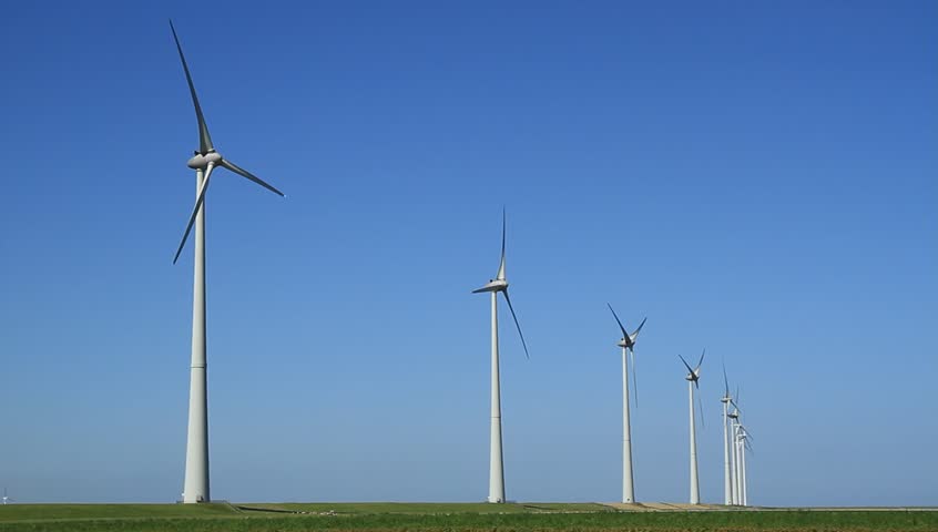 Row of modern wind turbines generating clean and renewable energy in the countryside.