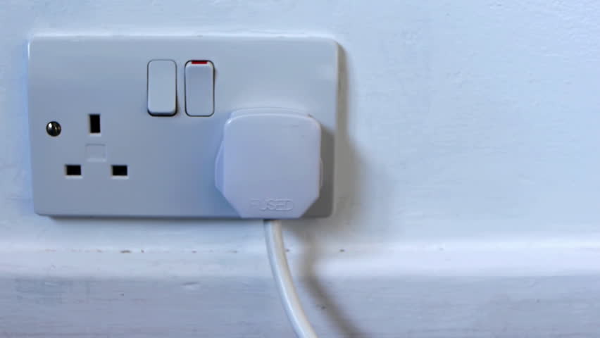 Camera moves down a cable until it gets to a plug in a mains socket which is then switched off and the plug pulled out.
