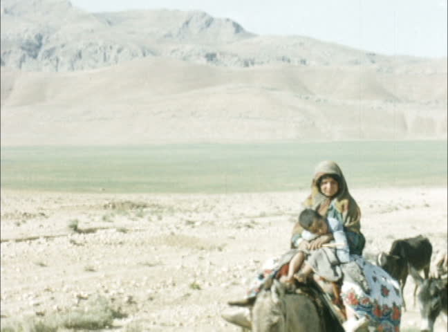 IRAQ - JULY 1956: Kurds moving their livestock along roadside in northern Iraq. Shot on 16mm film.