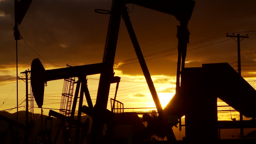 Oil well piston pumps at sunset