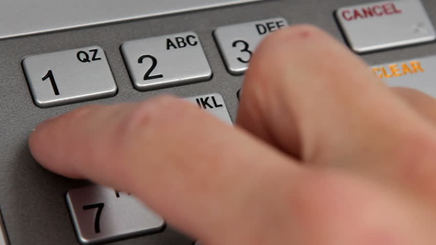 Close up of entering pin at ATM