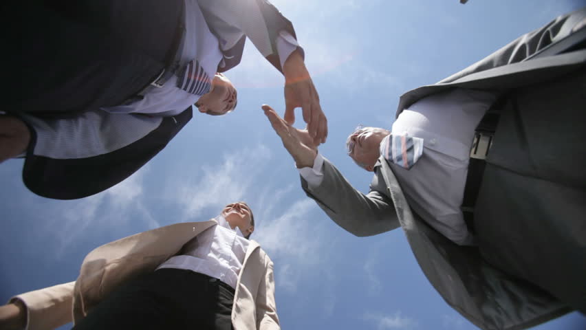 Three business people holding a meeting under the open sky