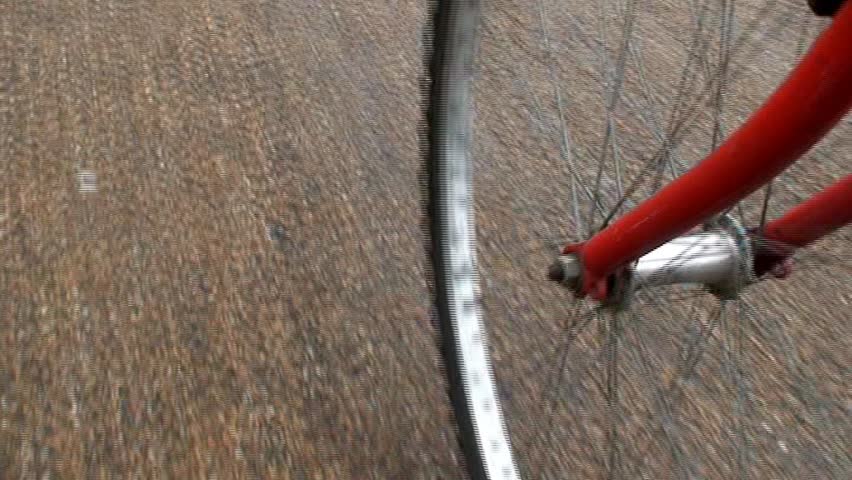 Cycling on asphalt / tarmac - shot of front bicycle wheel