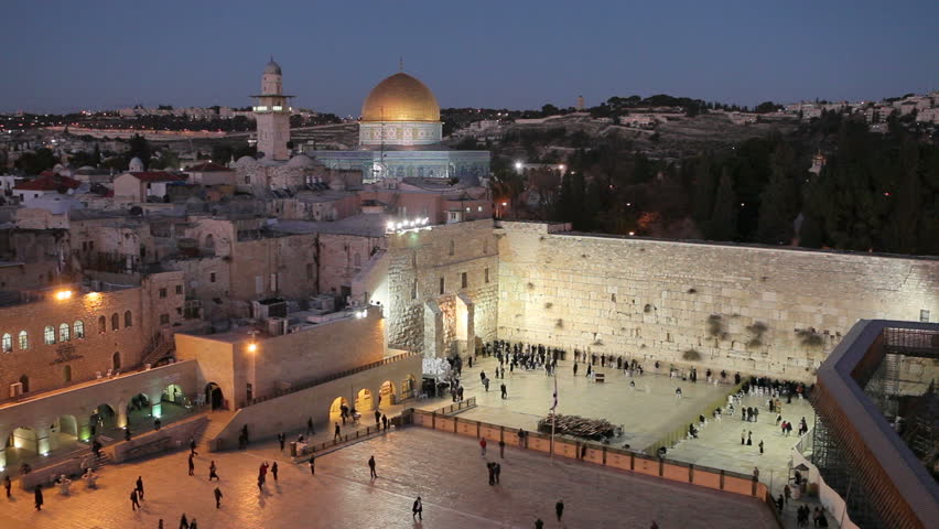 an evening shot of the Old City, Dome of the Rock, Jewish Quarter of the Western Wall Plaza, with people praying at the wailing wall, Jerusalem