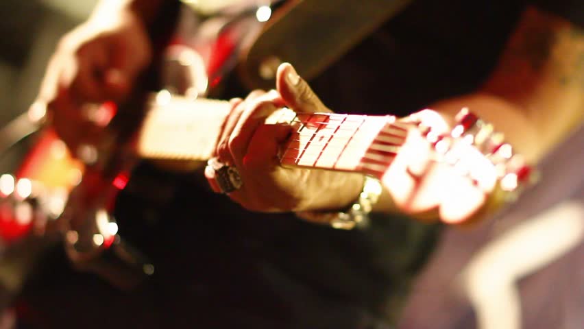 Man lead guitarist playing electrical guitar with fade out