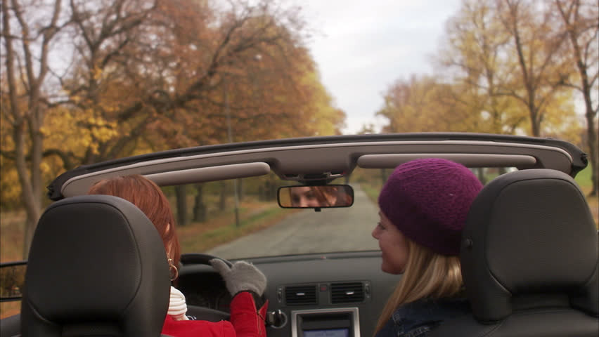 Young women in a cabriolet an autumn day