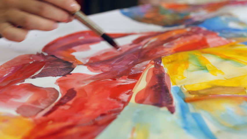 Woman artist painting watercolor paints