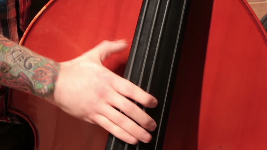 LIVERPOOL, MERSEYSIDE/ENGLAND - MAY 22: Unidentified man busks on a double bass on May 22, 2012 in Liverpool. Liverpool council wants to introduce compulsory permits for street performers.
