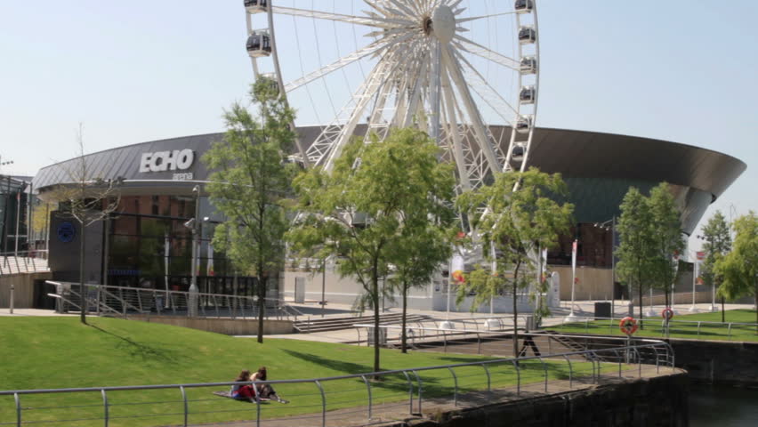 LIVERPOOL, MERSEYSIDE/ENGLAND - MAY 22: Two unidentified people sit on the grass at the Echo Arena on May 22, 2012 in Liverpool. The Arena holds conventions, sporting and musical events.
