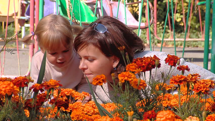 Mum and the daughter look at flowers