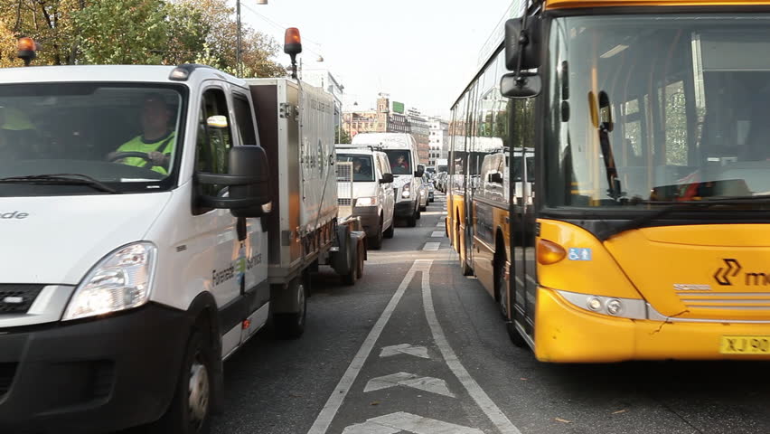 COPENHAGEN, DK - CIRCA 2011 - Cars and buses speed along a main street 