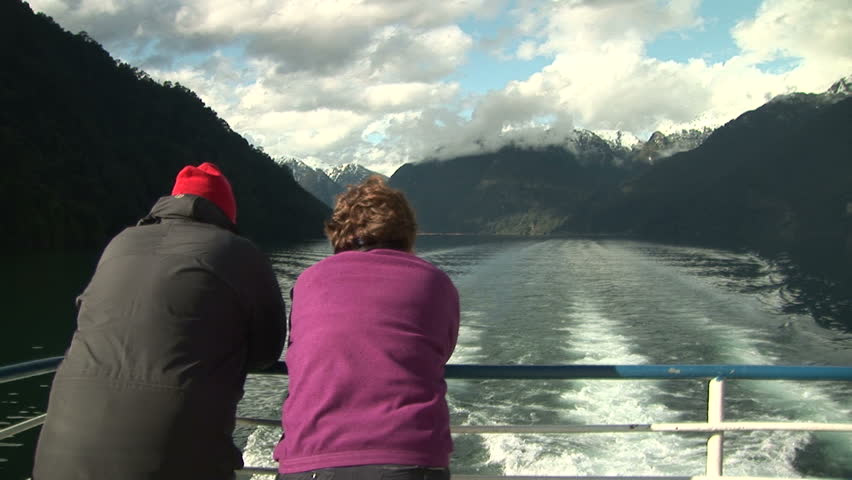 Senior couple gazing the wakes during a boat trip on lake