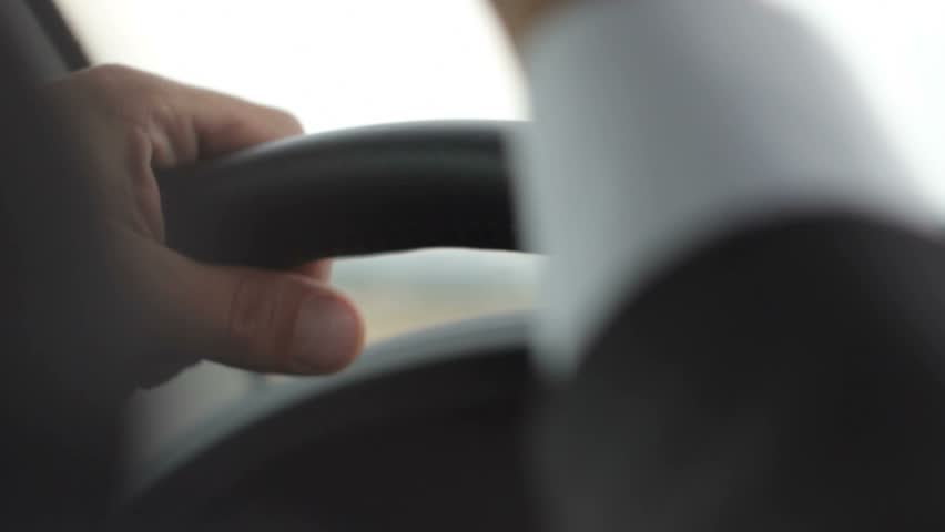 Close up of nervous hands on steering wheel