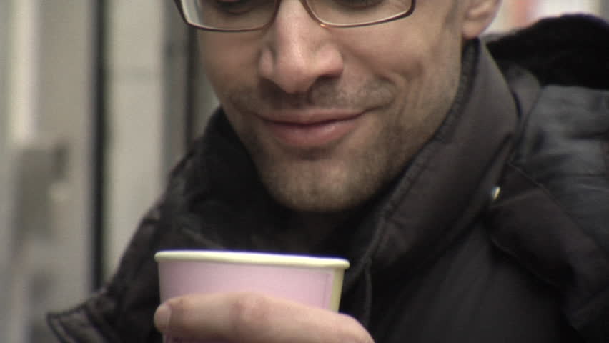 Close-up lockdown shot of a man from his nose to his shoulders outdoors in cold weather 
