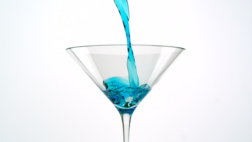 Pouring blue martini into martini glass shooting with high speed camera.