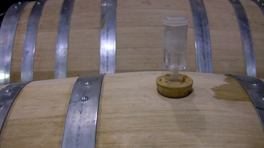wine fermenting in wooden cask