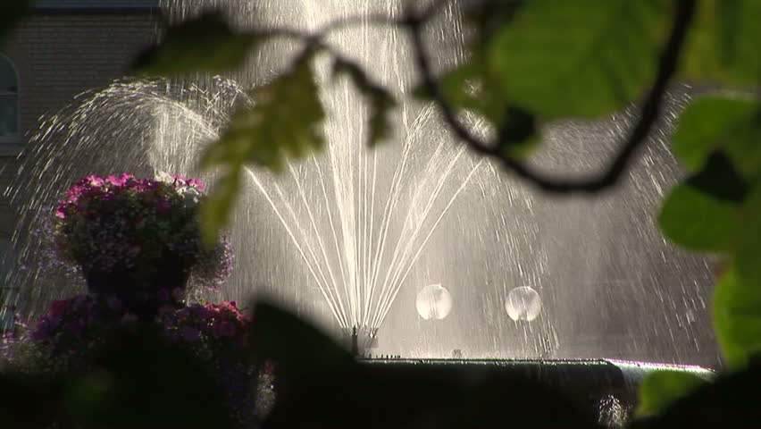 Back zoom of fine water spraying from fountain in city square Hull, UK