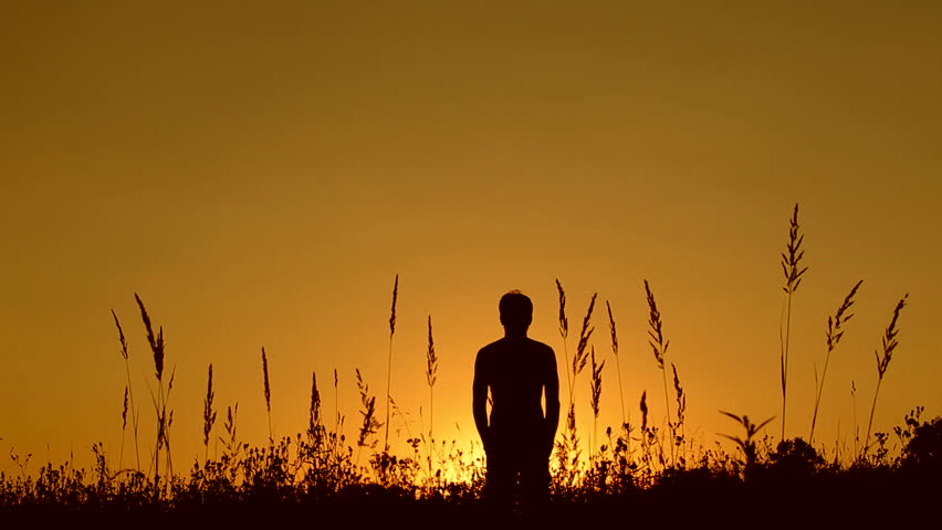 Silhouette of man on the sunset. Harmony concept.