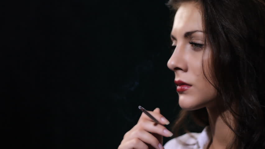woman smokes cigarette