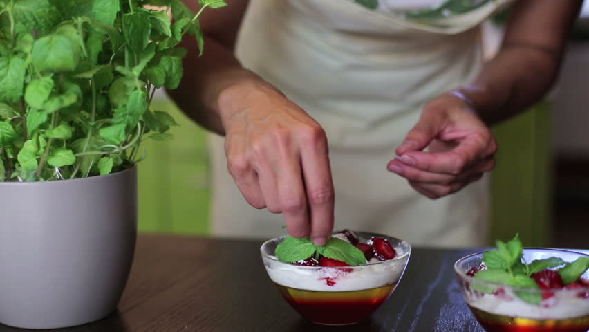 House wife decorating desserts in the kitchen
