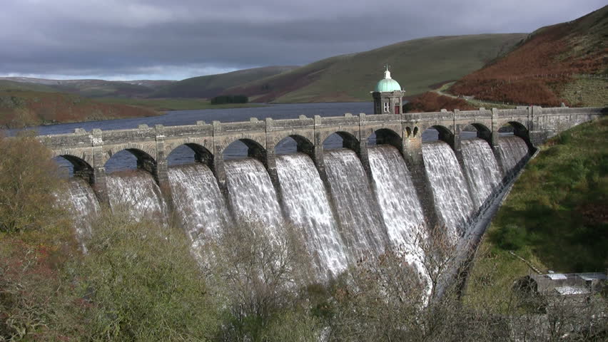 Craig Goch reservoir full and overflowing with water, Elan Valley, Wales.